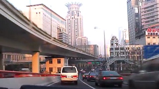 Video : China : A drive through the city skyline of ShangHai 上海 In the late afternoon ...  