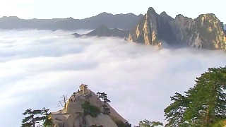 Above the clouds at the awesomely beautiful HuaShan 华山 …. Grab your walking boots and climb up over night (there are lights) to be ready for sunrise. Also featured is the famous `Plank Walk`.    HuaShan is one of China`s Five Sacred Mountains; it lies in ShaanXi province, about two hours from the city of Xi`An, in central China.  Hike above the clouds (at over 2,000 meters).  Sometimes people talk about `things to do before you die` - a trip to HuaShan (or HuangShan, EmeiShan, CangShan, WuDang or TaiShan) should be one of those ...      