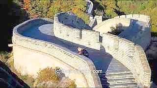 The Great Wall at BaDaLing 八达岭, BeiJing. The Great Wall of China is an immensely long man-made wall that was built to keep out invaders. The Great Wall spans nine provinces and its total length is 6,700 km (3,948 miles). The Great Wall extends from ShanHaiGuan (the `Old Dragon Head`), a seaport along the coast of BoHai, in the east (near BeiDaiHe resort) to JiaYuGuan Pass in GanSu Province in the west. Like a giant dragon, the Great Wall of China winds its way across grasslands, deserts and mountains. Listed as a World Heritage Site by UNESCO in 1987, the Great Wall (`Chang Cheng` in Chinese) is a true marvel and a testament to the long history of the Chinese civilization. Today, people from all over the world visit to walk on the Great Wall of China, to stand on a watchtower and view the wall snaking into the distance. This treasure is now protected so that future generations can see the Great Wall with the same wonder and amazement as we do now. Some parts of the Great Wall have been overwhelmed by the elements. Some parts have been covered by the desert. Others eroded by local people recycling the wall`s materials for constructions in their villages. Nevertheless, the Great Wall in large part still stands in silent splendor, enduring the passage of time and greeting the changes of the seasons as it has done for many hundreds of years. 